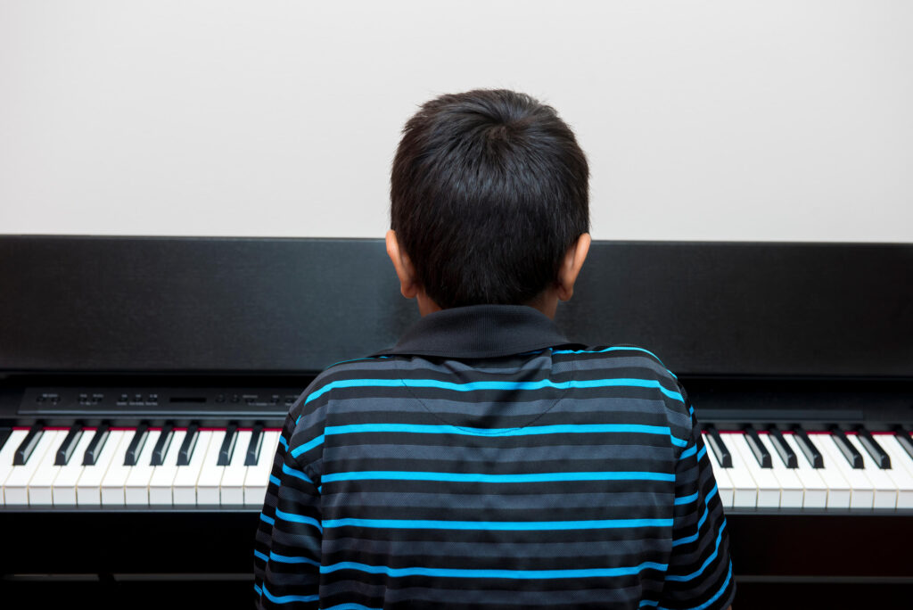 autistic child playing piano